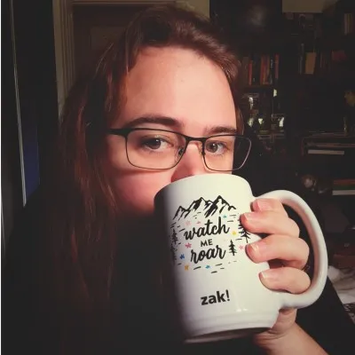 Zoe Montague, founder of Silverfern, drinking coffee from a “watch me roar” mug
